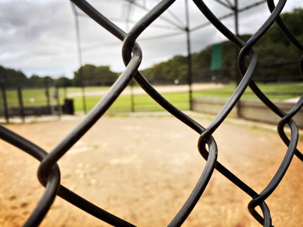 istock ChainLink Fence at an Overcast Ball field 1327001616