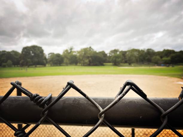 istock ChainLink Fence at an Overcast Ball field 1327001640