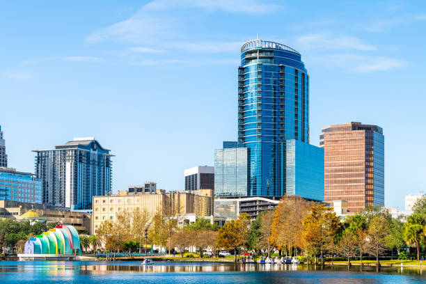 Orlando, Florida cityscape in Lake Eola park with scenic urban city skyscrapers buildings and art sculptures Orlando, USA - January 16, 2021: Florida city cityscape view in Lake Eola park in downtown with scenic urban city skyscrapers buildings and art sculptures at sunrise lake eola stock pictures, royalty-free photos & images