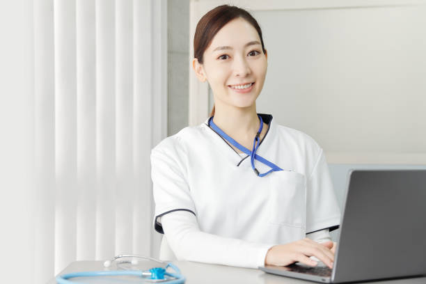 A woman working at a medical institution that operates a personal computer stock photo