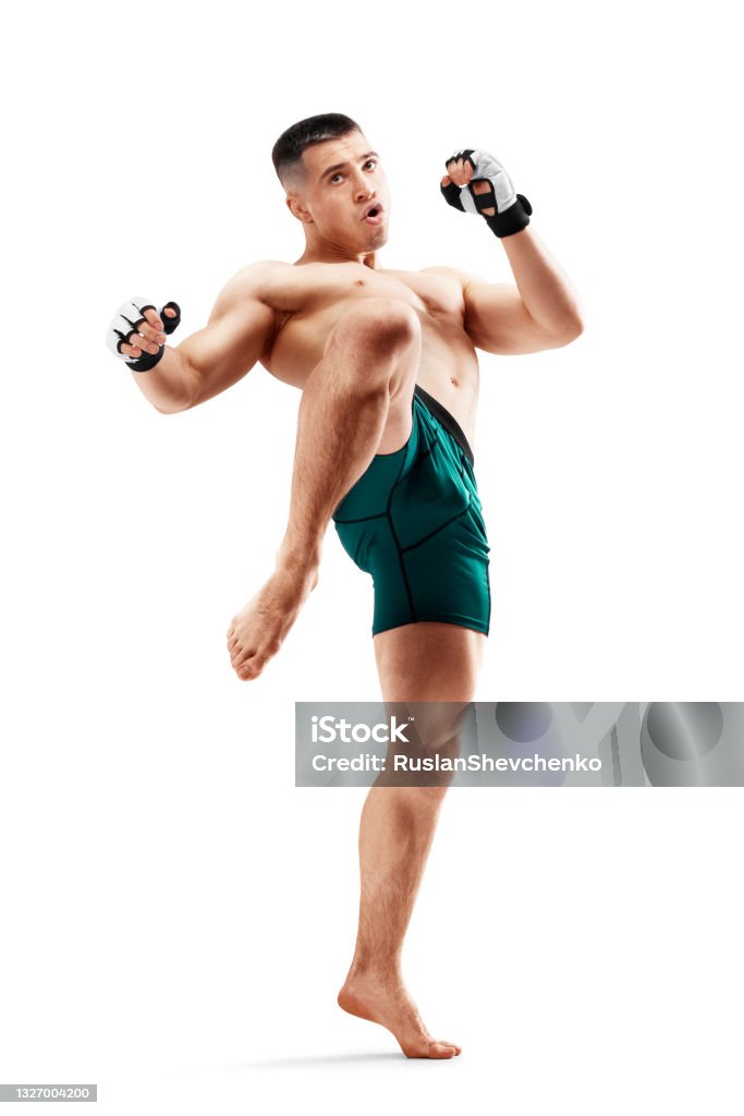 MMA. Knee kick. Male fighter with a knee kick. Sport. Isolated in white background MMA. Knee kick. Male fighter with a knee kick. Sport. Isolated in white background. Men Mixed Martial Arts Stock Photo