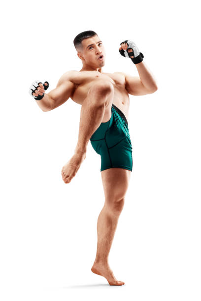 MMA. Knee kick. Male fighter with a knee kick. Sport. Isolated in white background MMA. Knee kick. Male fighter with a knee kick. Sport. Isolated in white background. Men combat sport stock pictures, royalty-free photos & images
