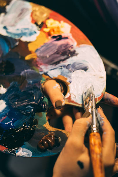 istock art school acrylic paint on palette brush in hands 1327007714