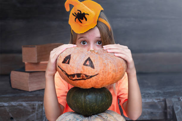 istock Girl with pumpkin on Halloween 1327009146
