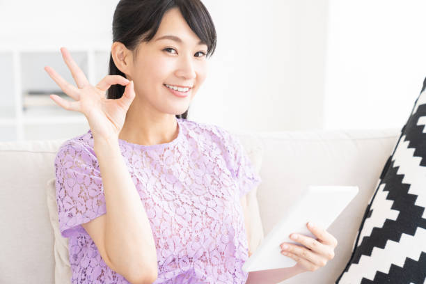 istock attractive asian woman to see a tablet computer 1327012935