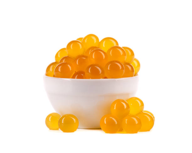 istock Yellow tapioca pearls for bubble tea isolated on white background. Tapioca pearls in white ceramic bowl. 1327016063