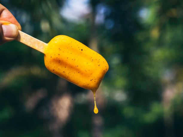 Woman with yellow popsicle.