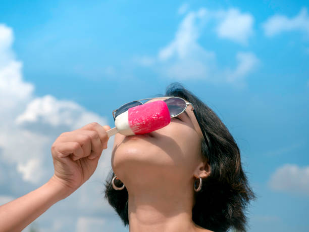istock Woman with pink popsicle. 1327016200