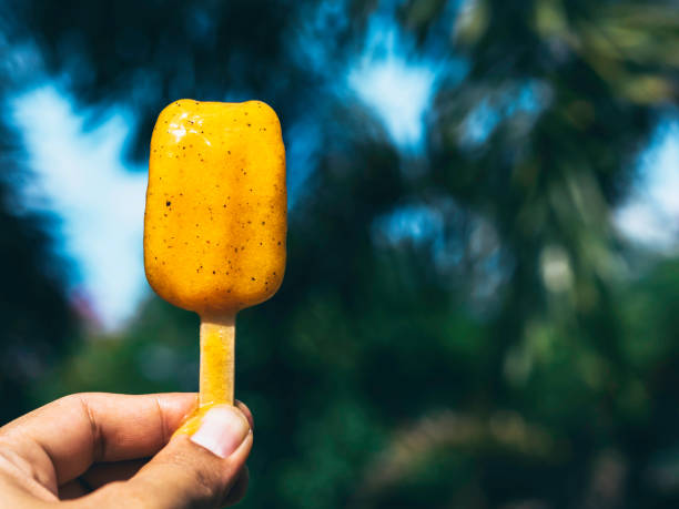 Woman with yellow popsicle.