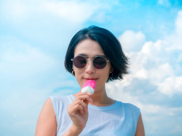 istock Woman with pink popsicle. 1327016211
