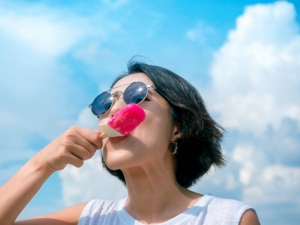 istock Woman with pink popsicle. 1327016215