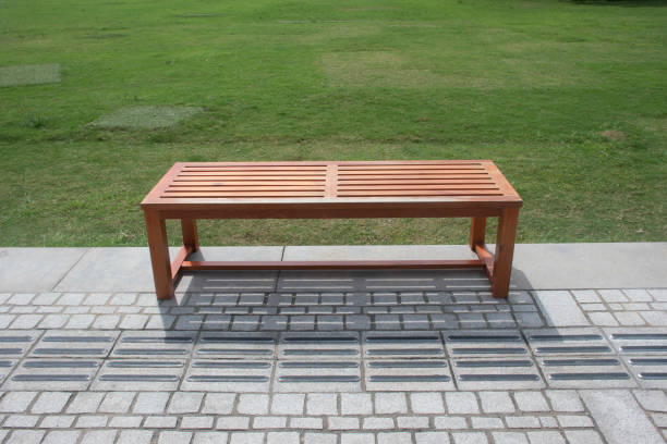 istock outdoor wooden bench next to grass lawn 1327016889