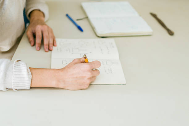 istock a woman ceramist drawing a project for a piece 1327022826