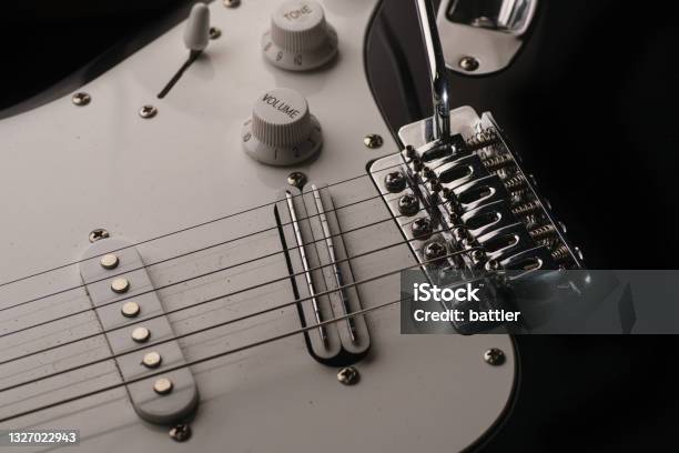 Black And White Electronic Guitar Close Up View Details Of Rock Guitar Strings Tremolo And Volume Control Stock Photo - Download Image Now