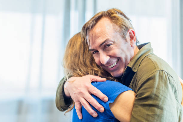 istock Mature man and woman hugging at home. 1327023067