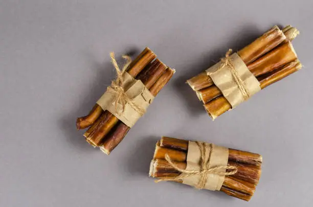 Photo of Bully sticks for dogs wrapped in brown paper and tied with twine