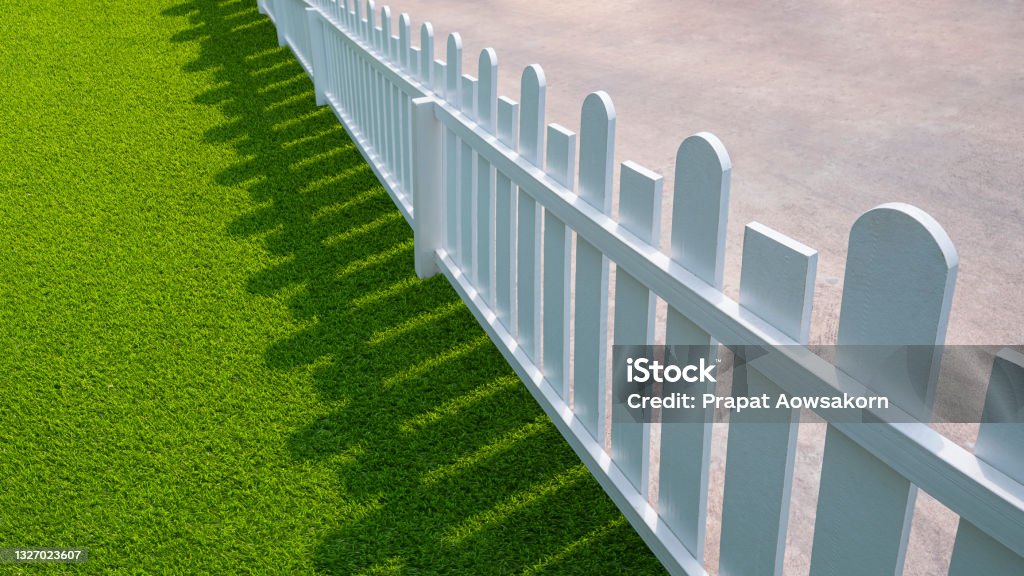 white wooden picket with green artificial turf in front yard area Wide angle and diagonal view of white wooden picket with green artificial turf in front yard area Fence Stock Photo