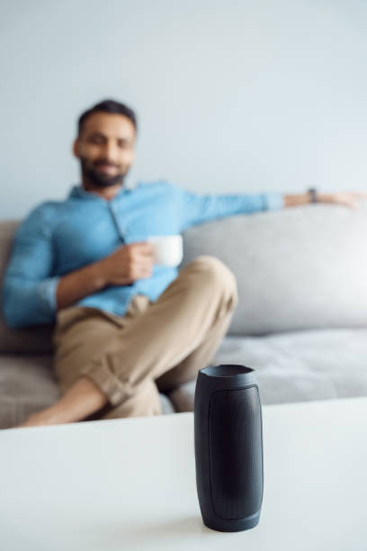 istock Focus on wireless speaker assistant and relaxed indian man with cup of coffee 1327027954