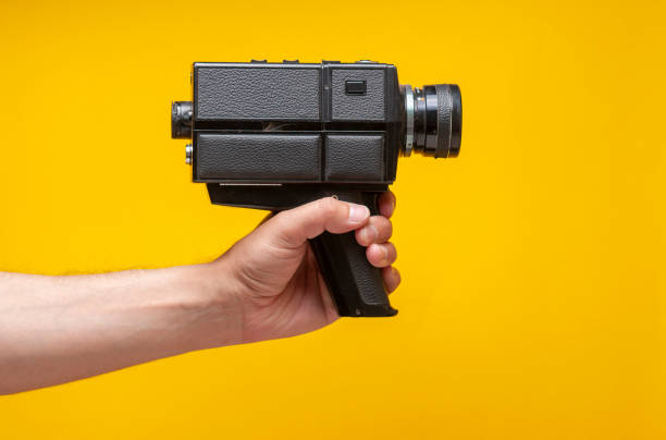 istock The man is holding a vintage film camera 1327028896