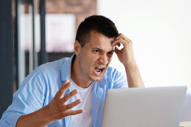 istock Angry leader talking chat with to his coworker using laptop. Video conference concept 1327032248
