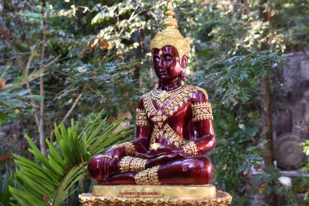istock Deep Red and Gold Seated Buddha 1327035413
