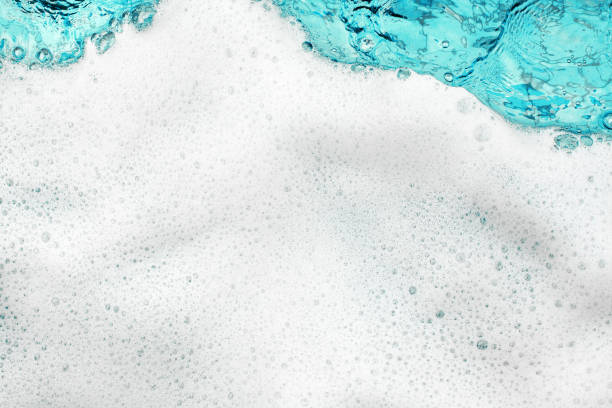 istock White foam blue water background closeup, sea or ocean foam wave pattern, froth bubbles texture, soap spume backdrop, cleaning soap sud, lather surface, soapy detergent, laundry, foamy bathtub, shower 1327035972