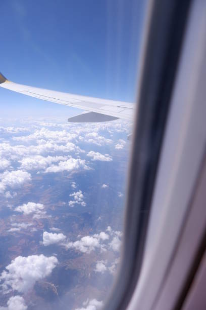 istock amazing clouds and sky view from plane window 1327037873