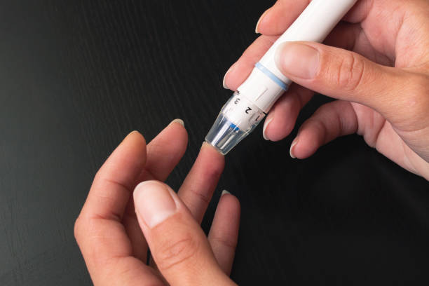 istock The lancet device pierces the finger closeup 1327039496
