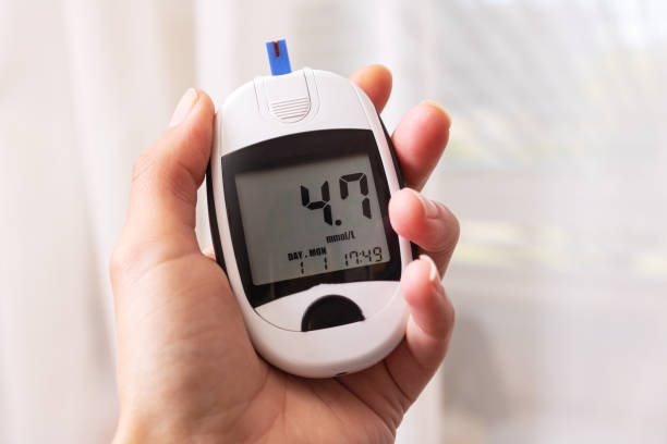 istock Blood glucose meter in hand on white background 1327040251