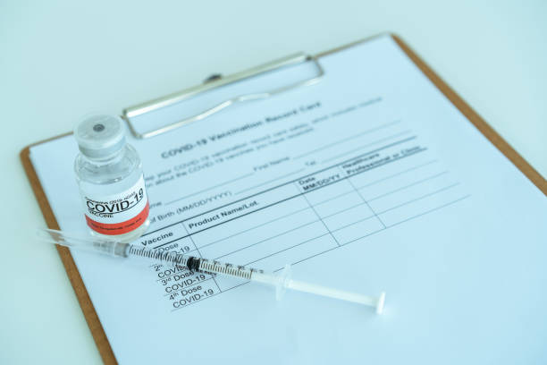 istock COVID-19 cure vaccine and vaccination record document. 1327040261