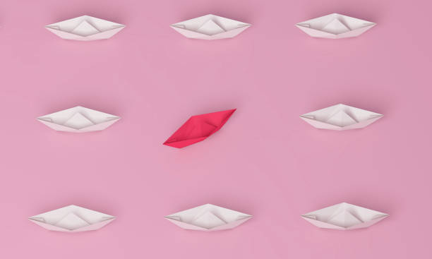 istock Change concepts with red paper ship leading among white on blue background. Women's leadership concept. 1327040659