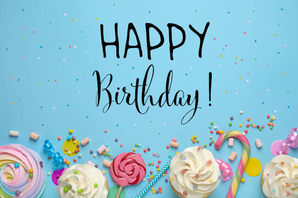 istock Happy Birthday! Flat lay composition with cupcakes on light blue background 1327041517