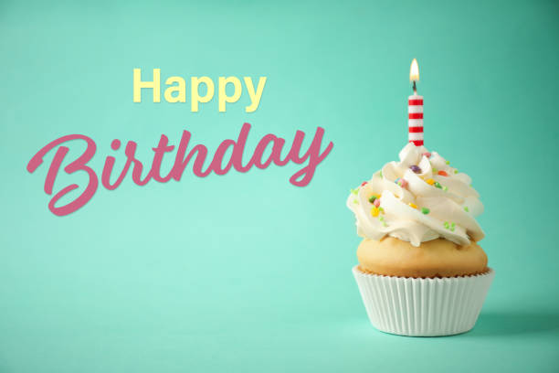 istock Happy Birthday! Delicious cupcake with candle on light green background 1327042611