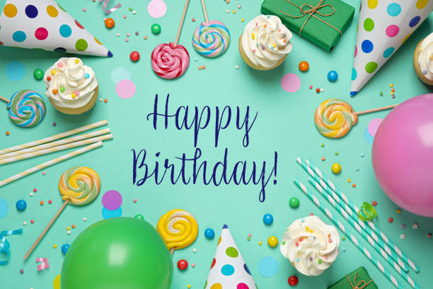istock Happy Birthday! Flat lay composition with cupcakes on light green background 1327042715