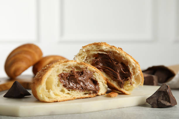 istock Tasty croissant with chocolate on light grey table 1327042833