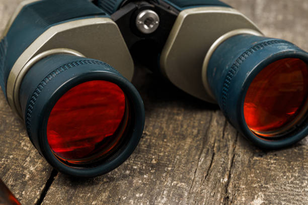 istock Hunting equipment binoculars on wooden background close up 1327043335