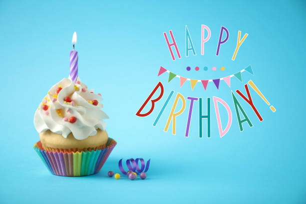 istock Happy Birthday! Delicious cupcake with candle on light blue background. 1327043903