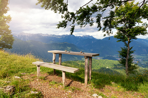 Bench and table in the mountains with view on Alps and alpine valley