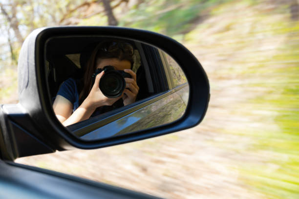 istock Woman camera selfie car. Blurred motion nature background 1327044338