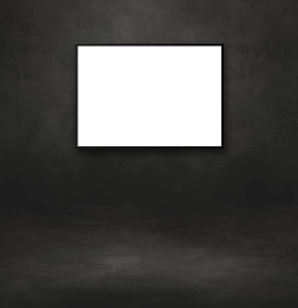 istock Blank picture frame hanging on a black wall 1327045231