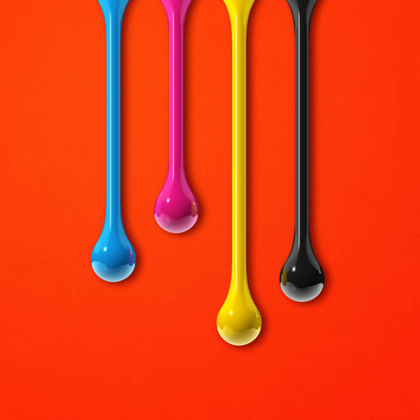 istock cmyk ink drops on red paper square background 1327045278