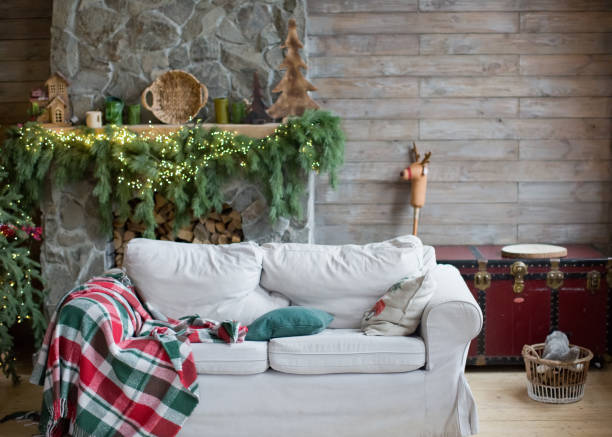 Rustic Christmas interior with decorations Rustic Christmas interior with white sofa, Christmas tree with green and red decorations chalet photos stock pictures, royalty-free photos & images