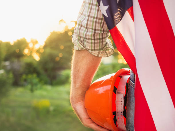 istock Handsome man holding US Flag. Labor and employment concept 1327051184