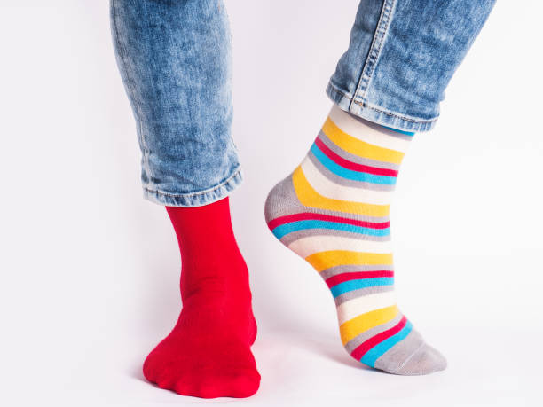 istock Men's legs and bright socks. Without shoes 1327052458