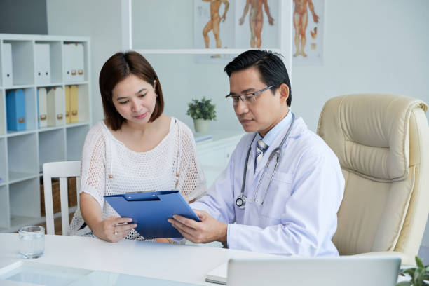 istock Female Patient Filling Document before Examination 1327052833
