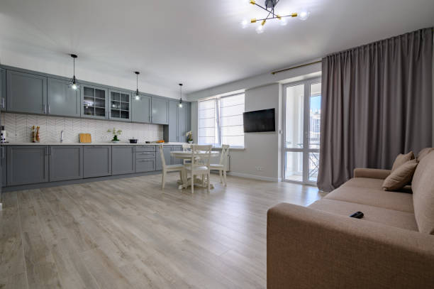 istock Trendy grey and white modern kitchen furniture in studio apartment 1327052915