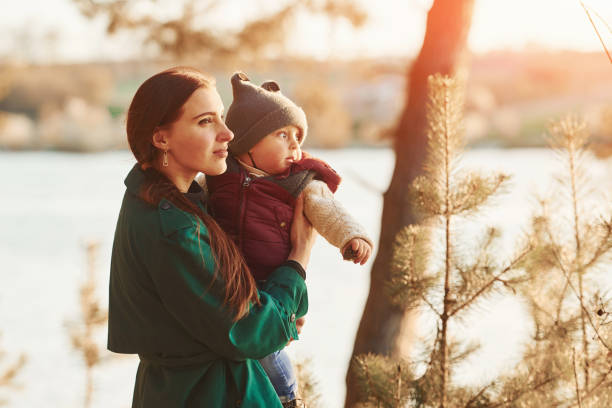 istock Mother with her little son have a walk in spring forest at daytime 1327057728