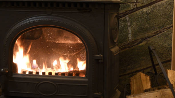 istock Antique cast iron wood based burner parlor stove with flaming fire inside 1327057759