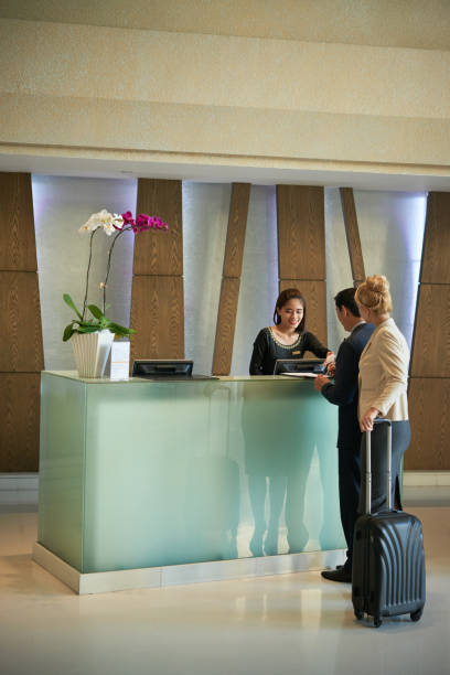 istock Business People at Hotel Reception 1327058303