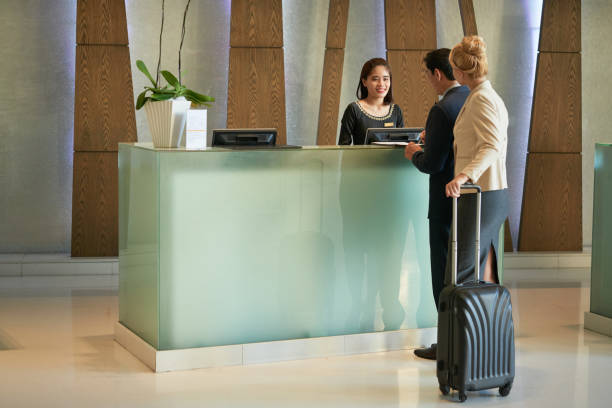 istock Smiling Receptionist Working at Hotel Lobby 1327058304